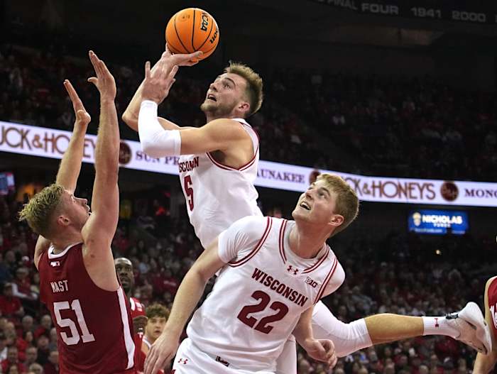 Wisconsin forward Tyler Wahl scores during the second half as Nebraska's Rienk Mast defends.